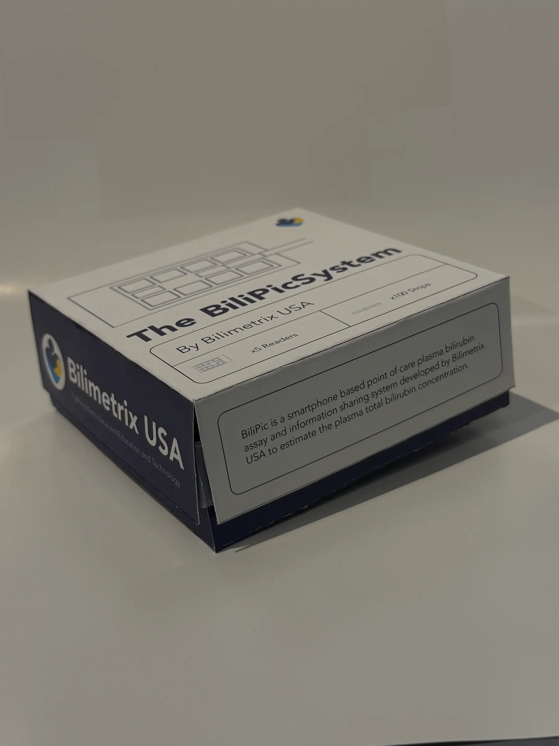 The same printed package with the lid lifted slightly, revealing the deep-blue base tray and the branded 'Bilimetrix USA' side panel.
